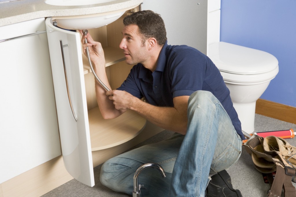plumber working on sink plumber working on sink