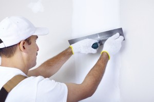 plasterer using plastering tools