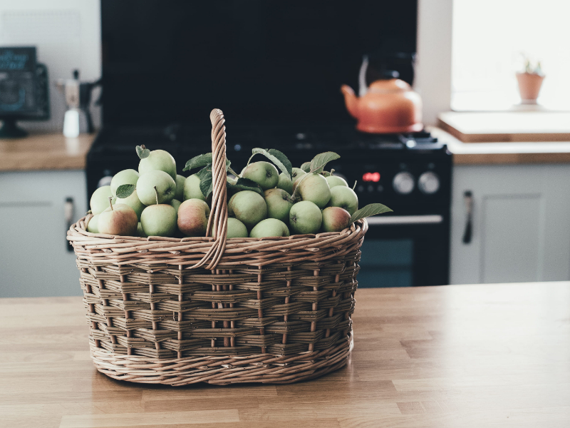stove in background with basket of fruit on worktop