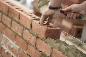 Bricklayer setting bricks on a construction site
