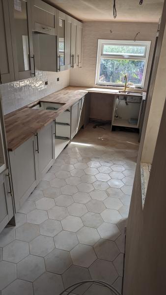 Wall and floor tiling in kitchen renovation 